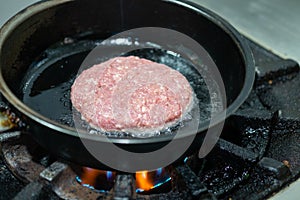 Beef burgers cooking in kitchen