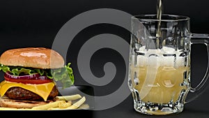 Beef burgers with french fries and a mug of beer