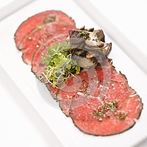 Beef carpaccio with mushrooms.