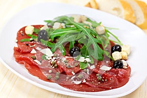 Beef carpaccio with pepper, rucola and parmesan