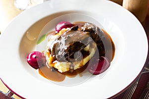 Beef cheek with mashed potatoes and currant oil