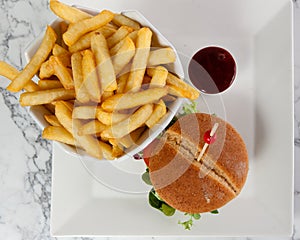 Beef cheese hamburger french fries tomato ketchup