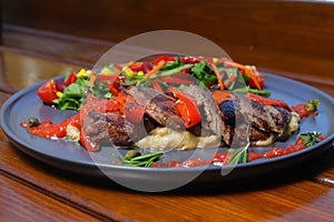 beef chop steak with salad , fried potatoes and mustard sauce in dish.