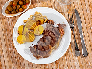 Beef entrecote with baked potato in skins and mustard