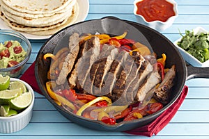 Beef Fajitas with Bell Peppers on a Blue Wood Table photo