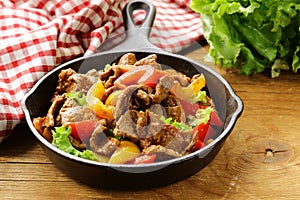 Beef Fajitas with colorful bell peppers in pan