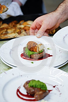 Beef fillet with porcini mushrooms, hands of a cook. Steak filet mignon with porcini mushrooms and creamy mushroom sauce with