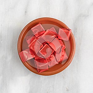 Beef flavored bouillon cubes wrapped in a small bowl