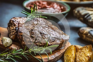 Beef grilled steaks with barbecue sauce roasted potatoes and rosemary