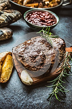 Beef grilled steaks with barbecue sauce roasted potatoes and rosemary