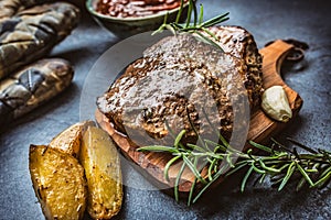 Beef grilled steaks with barbecue sauce roasted potatoes and rosemary