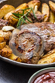 Beef grilled steaks with barbecue sauce roasted potatoes and rosemary