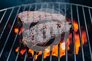 Beef grilling over charcoal barbecue, sizzling and savory