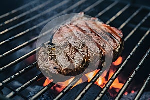 Beef grilling over charcoal barbecue, sizzling and savory