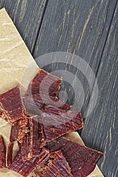 Beef jerky on wooden board, close-up