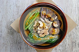 Beef Kare Kare sa Buntot with nuts served in a dish isolated on grey background side view