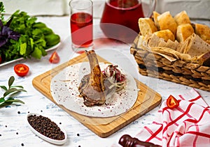 Beef lamb chop meal in lavash on wooden plate