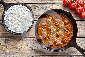 Beef Madras traditional slow cook Indian spicy chili lamb meat food with rice and tomatoes