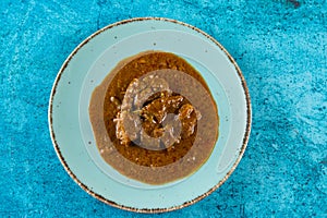 Beef masala curry in a plate isolated on background top view of indian, pakistani and bangali food