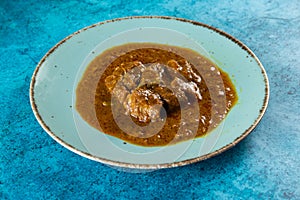 Beef masala curry in a plate isolated on background top view of indian, pakistani and bangali food