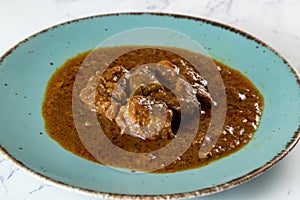 Beef masala curry in a plate isolated on background top view of indian, pakistani and bangali food