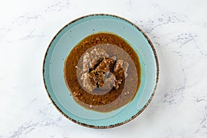Beef masala curry in a plate isolated on background top view of indian, pakistani and bangali food