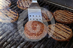 Beef meat burger patty on a hot smoky barbeque grill