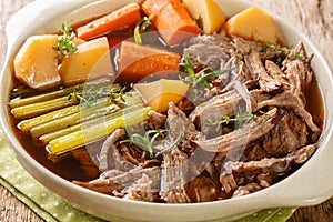 Beef meat and vegetables stew Homemade Slow Cooker Pot Roast with Carrots, celery and Potatoes close up in the bowl. Horizontal