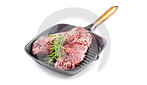 Beef meeat Rib-Eye steak wit rosemary salt and pepper in grill pan isolated on white