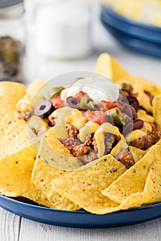 Beef nachos with jalapeno, olives, tomato, beans cheddar cheese