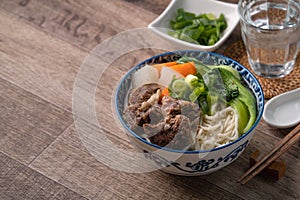 Beef noodle soup. Close up of Taiwanese famous food in a bowl on wooden table