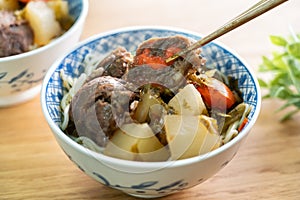 Beef noodle soup. Taiwanese famous food in a bowl on wooden table