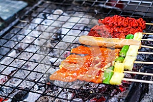 Beef, pork, beef, chicken and sausage are cooked on the stove