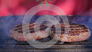 Beef or pork meat barbecue burgers for hamburger prepared grilled on bbq fire flame grill. Tasty meat for burger cooked