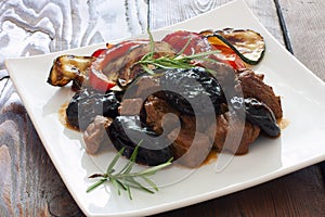 Beef with prunes and vegetables photo