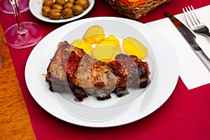 Beef rack with potato and olives photo