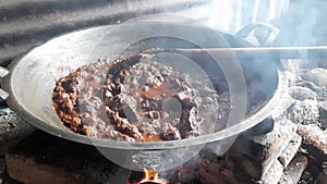 Beef Rendang cooked in a stove with wood fire, a popular traditional Indonesian dish