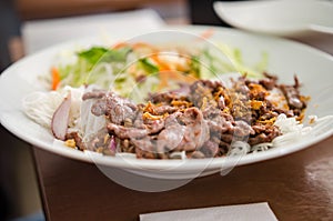 Beef with rice noodles and fresh vegetables