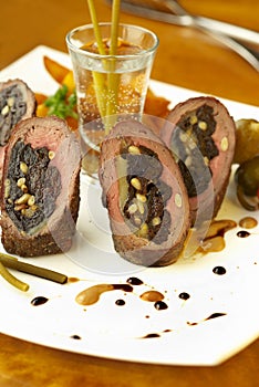 Beef rolls with prunes, cheese and pine nuts