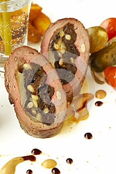 Beef rolls with prunes, cheese and pine nuts