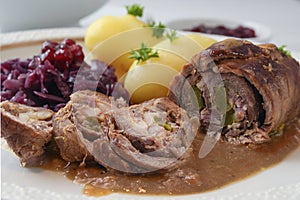 Beef roulade with red cabbage, potatoes and sauce, german meat r