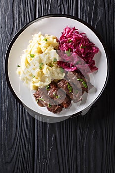 Beef Rouladen with gravy on a plate served with mashed potatoes