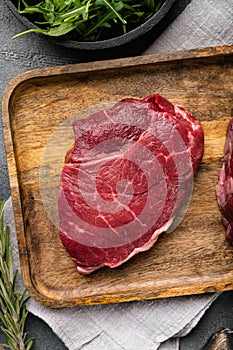 Beef rump meat steak, on gray stone table background, top view flat lay