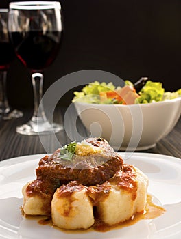 Beef with sauce and gnocchi