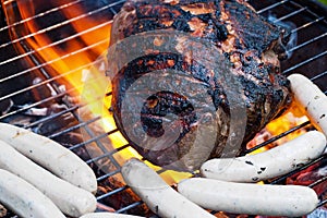 Beef and sausages on grill