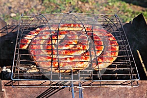 Beef sausages grilled on a coals. Kielbasa barbecue