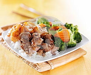 Beef and shrimp teriyaki combination on white rice