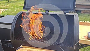 Beef sirloin cap, also known as picanha is being seared on the open flame on pellet grill