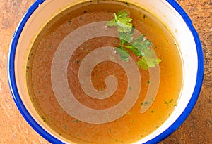 Beef soup with parsley close up