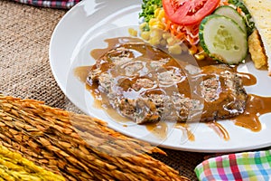 Beef steak with black pepper sauce , salad and French fries on s